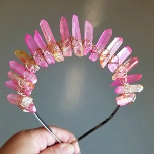 Detailed close-up of pink and orange quartz crystals hand-wrapped in gold wire on a headband