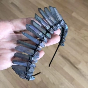 Close-up of handmade dark raw crystal points wrapped with black wire on a bridal headband
