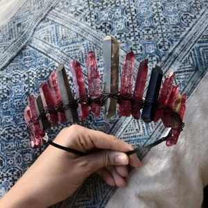 Close-up of handmade crown featuring raw red and black natural crystal points