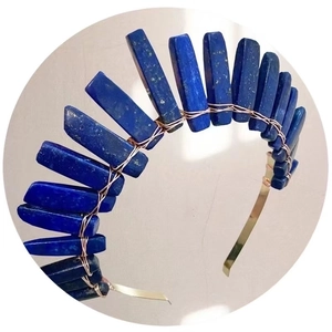 Detail of handcrafted blue lapis lazuli stones woven with gold wire on a bridal crown