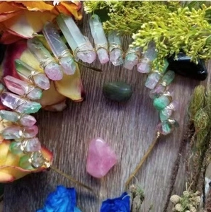 Handmade natural crystal quartz crown headband with gold wire on floral wooden background