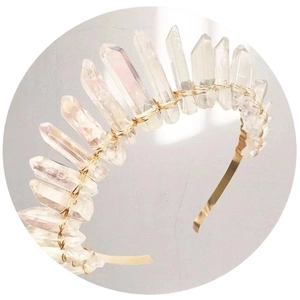 Detailed view of natural white crystal crown with gold wire wrapping for bridal headwear