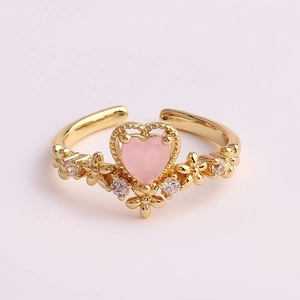 Detail of gold floral ring with pink heart-shaped stone and cubic zirconia accents