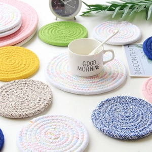 Detail of colorful woven cotton rope coasters in various sizes and vibrant pastel colors
