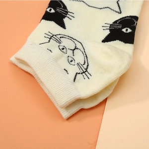 Unisex cream cotton ankle socks featuring cute black cat prints and ribbed cuffs