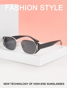 Detail of premium black square sunglasses with a distinct golden K-shaped metal hinge hinge