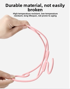 Detailed view of flexible pink plastic baby clothes hanger showing strong durability