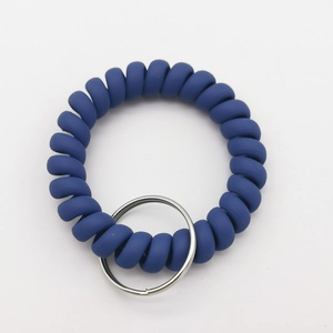 Close-up of matte dark blue spiral telephone cord keychain with a silver metal ring