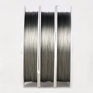 Three spools of metallic silver-gray jewelry wire for DIY bracelet making and repairs