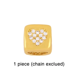 Close-up of golden heart-shaped cubic pendant with sparkling diamond rhinestones