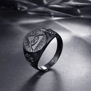 Detailed view of black stainless steel ring featuring embossed Eye of Providence relief