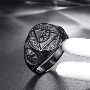 Macro view of vintage punk black stainless steel ring featuring the eye of providence