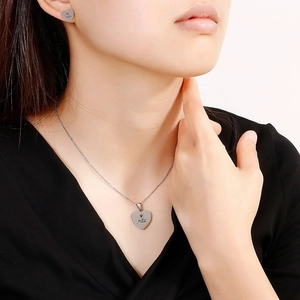 Elegant silver heart jewelry set with crown engraving worn by a model for Mother's Day gift