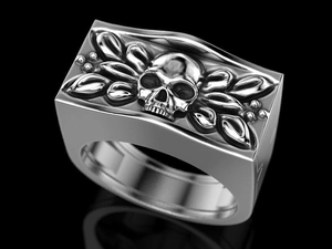 Detailed relief of silver skull and leaf patterns on a punk style metallic ring band