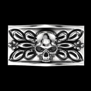 Detailed view of silver skull emblem with intricate Gothic patterns on black background