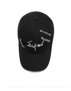 Top view of black cotton baseball cap with white embroidery and silver metal chain details