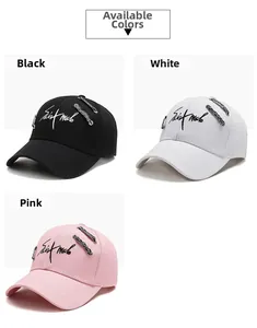Detailed view of street style baseball caps in black, white, and pink with embroidery