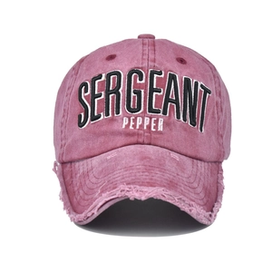 Detail of distressed rose pink cotton baseball cap with Sergeant Pepper 3D embroidery