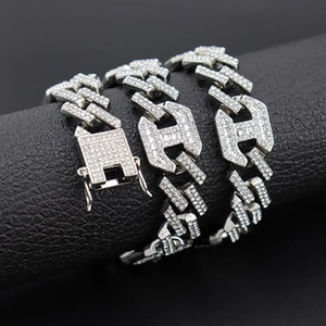 Close-up of a silver hip-hop chain necklace with clear rhinestones and a square box clasp