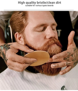 Detail showing a professional oval wood beard brush with natural boar bristles in use