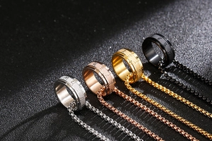 Close-up of rotatable titanium steel rings in silver, gold, rose gold and black colors