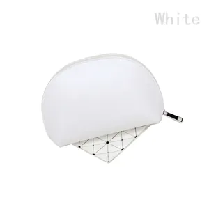 Detailed top view of white shell-shaped makeup bag with premium PU leather and metal zipper