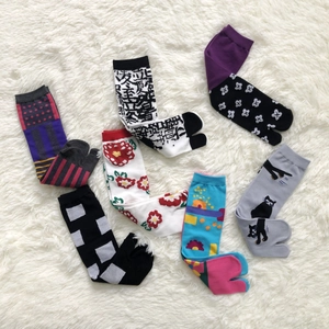 Flat lay of multiple colorful jacquard tabi socks with floral and geometric patterns