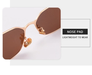 Detail of adjustable gold metal nose pads on sunglasses for lightweight wear