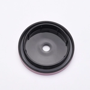 Matte black stainless steel cup lid with central straw hole on a white background