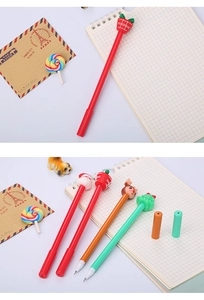 Detailed view of four Christmas cartoon pens with Santa, elk, and tree toppers on a desk