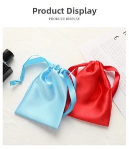 Close-up of sky blue and red satin drawstring gift bags with a glossy silk texture