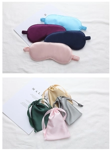 Detail of silk sleep masks and matching drawstring bags in various pastel satin colors