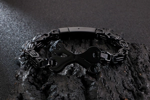 Détail d'un bracelet byzantin noir avec design de clé industrielle sur pierre sombre