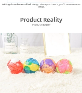 Close-up of four colorful geometric textured pet toy balls on white plush carpet