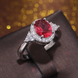 Classic 925 silver ring featuring a large oval red gemstone with zircon accents