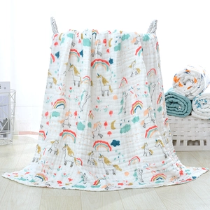 Detail of multi-layer cotton gauze baby towel with colorful unicorn and rainbow prints