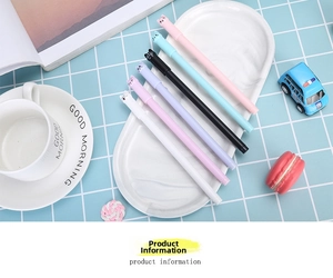 Set of six cute cat-themed gel pens in pastel colors arranged on a white tray