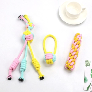 Detailed macro of pink and yellow cotton rope pet chew toys in three various shapes