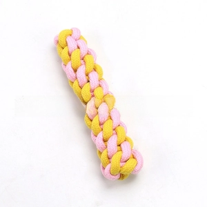 Detail of pink and yellow braided cotton rope dog toy for chewing and dental health