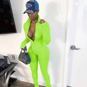 Detail of neon green ribbed bodysuit featuring a functional front zipper and hood