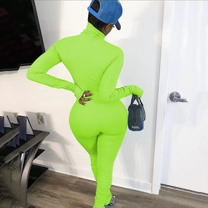 Back view of sexy neon green long sleeve ribbed jumpsuit with high collar and gathered ankles