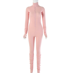 Detailed view of pink ribbed bodysuit featuring front zipper and ruched sleeve cuffs