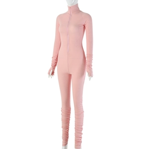 Detail showing pink ribbed knit fabric texture and front zipper on long sleeve jumpsuit