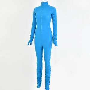 Detail of blue long sleeve jumpsuit featuring front zipper and stacked ruched sleeve cuffs