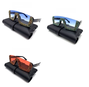 Detailed view of rhinestone embellished half-frame sunglasses in blue and red color options