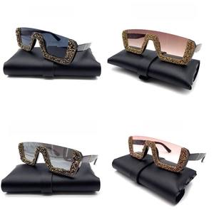 Detail of four colorful oversized half-frame sunglasses with crystal rhinestones