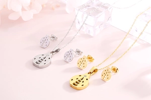 Detail of gold and silver hollow ladybug jewelry set with necklace and earrings