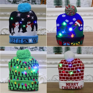 Detail view of four LED knitted Christmas hats featuring snowman and dinosaur patterns