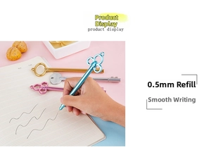 Close-up of vintage key-shaped 0.5mm gel pen writing on notebook in various metallic colors