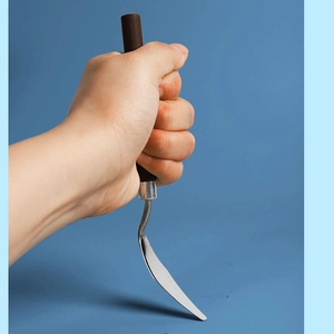 Artist holding stainless steel palette knife with a wooden handle for oil painting mixing